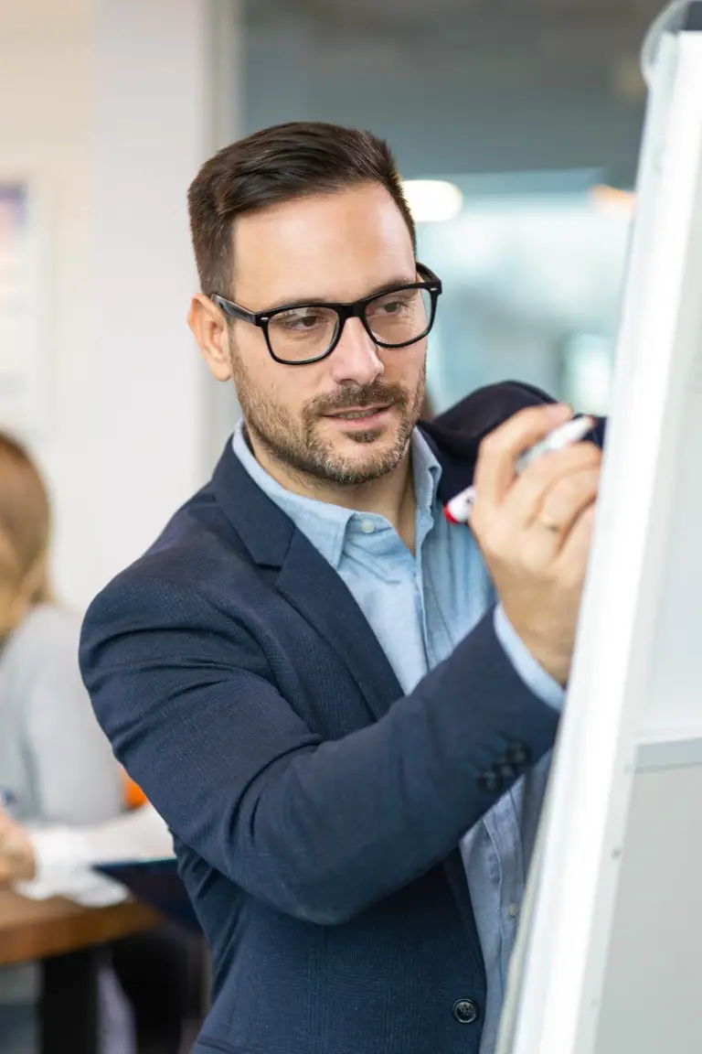 focused businessman using whiteboard write key points presentation aiming outline business plan successful company growth business partners